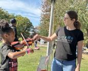 Someone from the Cleveland Institute of Music works with a child at Parade the Circle.