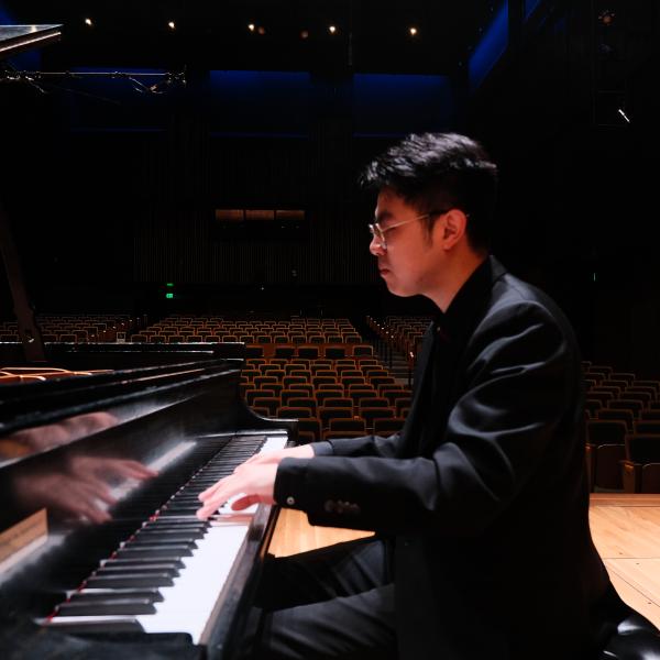 Danny Su at the piano on stage in Kulas Hall 